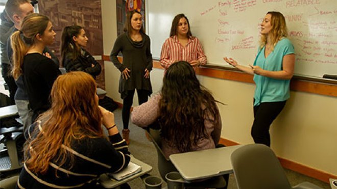 Students discuss advertising campaign strategy.