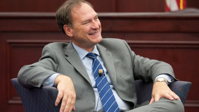 Chief Justice sits in a classroom