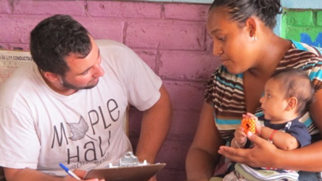 Student collects health info from a woman and baby