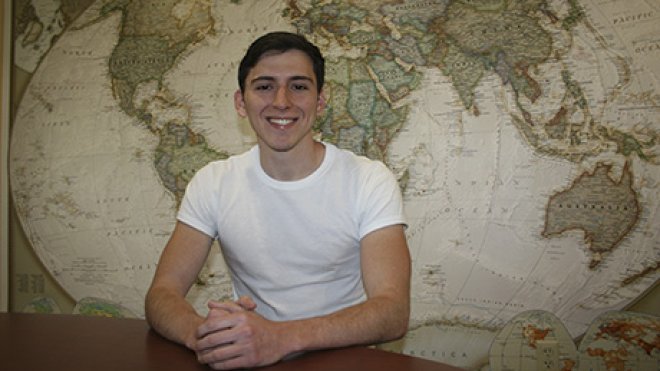 Anthony Salazar sits inside a classroom