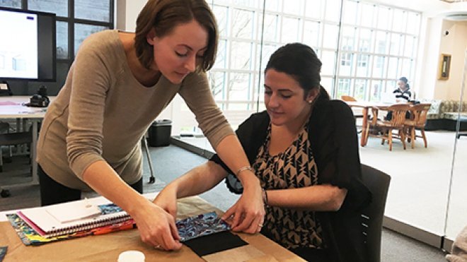 Professor teaches student bookbinding