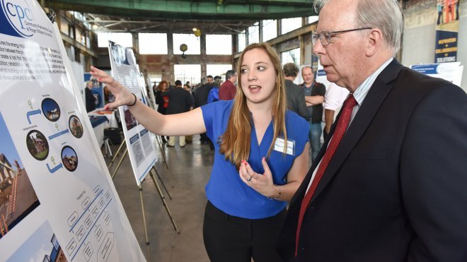 A student explains her research to a professor.