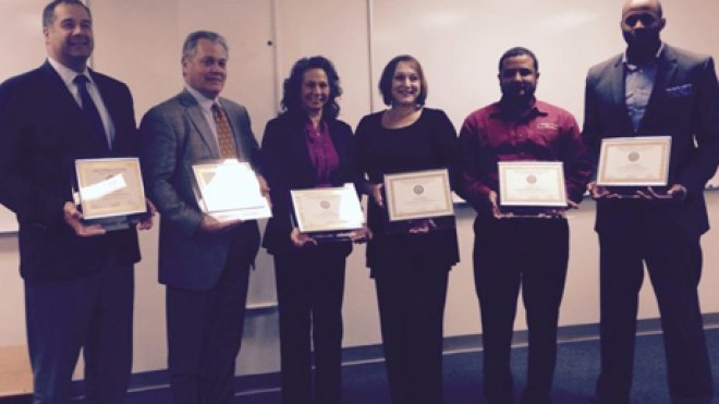 Graduates pose with certificates