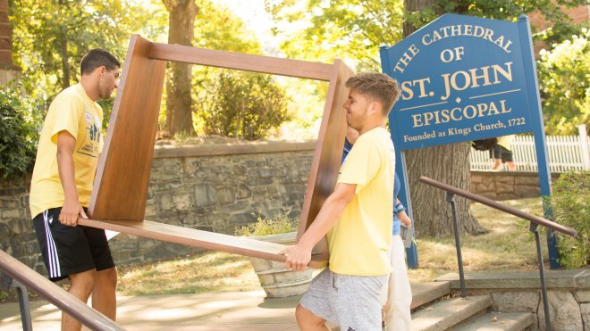 Students help move items from a church