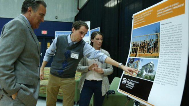 Student demonstrates info on his poster