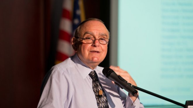 Man speaks at podium