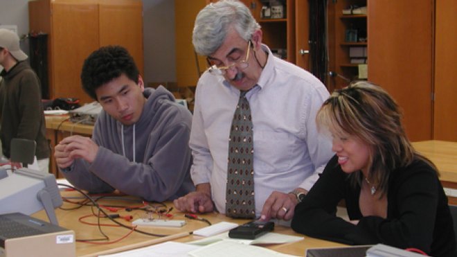 A professor works with students.