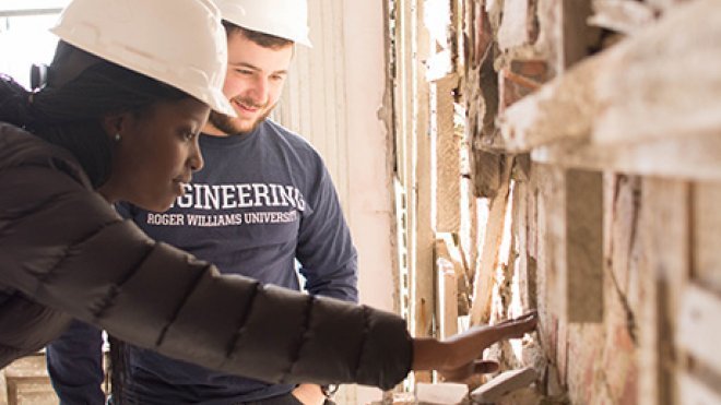 Engineering students inspect a structure.