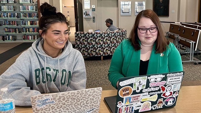 Collection Strategies Librarian Haley Lott and sophomore Haley Gifford sit at their laptops in the library