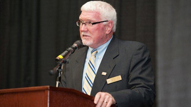 Man speaks at podium