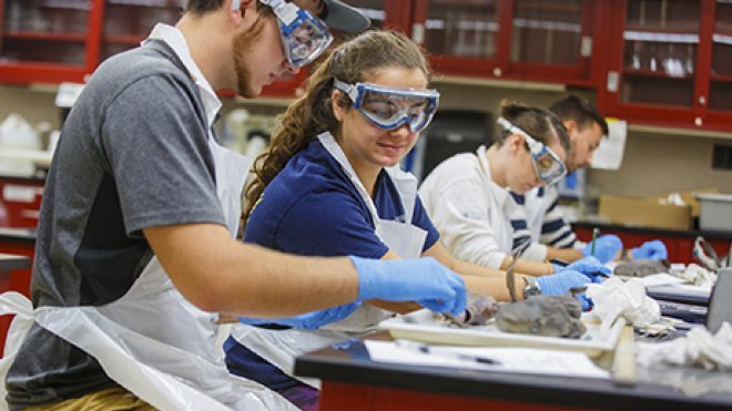 Students work on an experiment inside the chemistry lab.