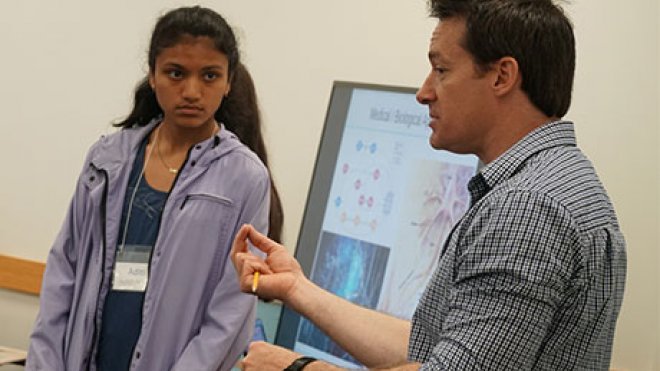 Professor instructing a classroom.