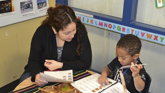 A teacher goes over a lesson with an elementary school student.