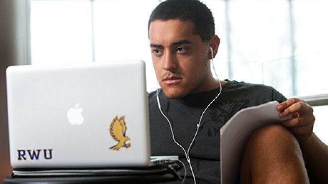 image of RWU student working remotely on laptop