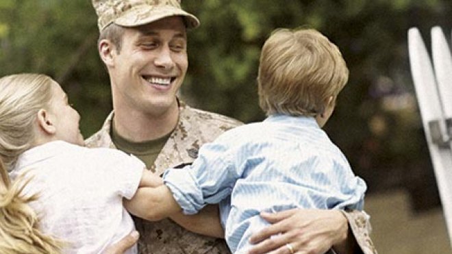 Soldier holding two boys