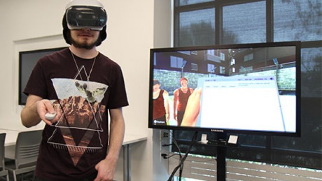 Student using virtual reality to take a science lab.