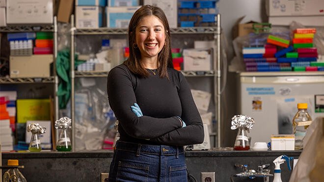 Lily Winsten stands in her lab.