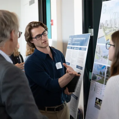 A student presenting his project to colleagues