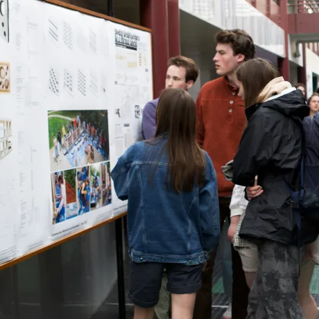 Students in the atrium looking at project displays