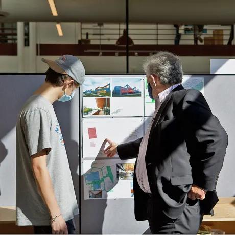A student and a Dean discussing their project in studio