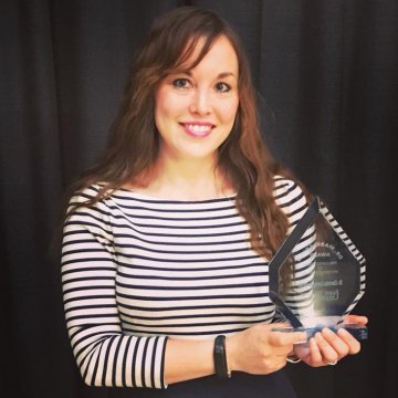 photo of Dr. Charlotte Carrington-Farmer holding an award