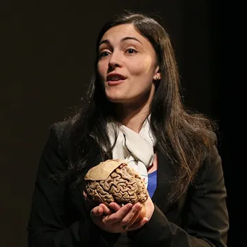 photo of Assistant Professor of Psychology Victoria Heimer-McGinn holding a model of a human brain