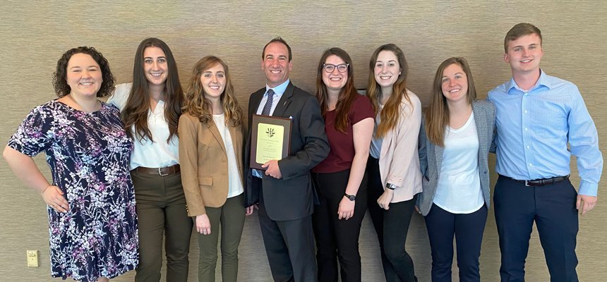 RWU Forensic & Legal Psychology students stand with a faculty member