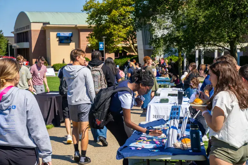 Students learning about clubs and orgs at the involvement fair