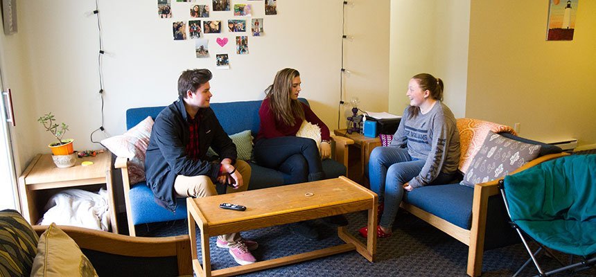 Students lounging in their living room.