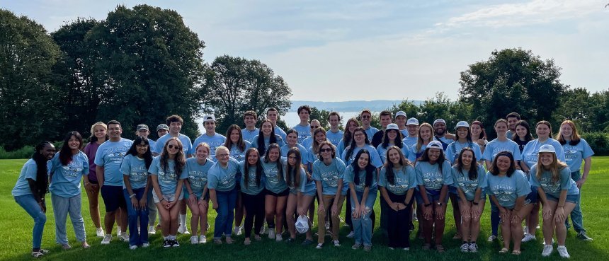 group of peer mentors smiling on the RWU campus