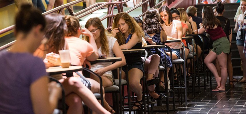 Students eating and studying at tables