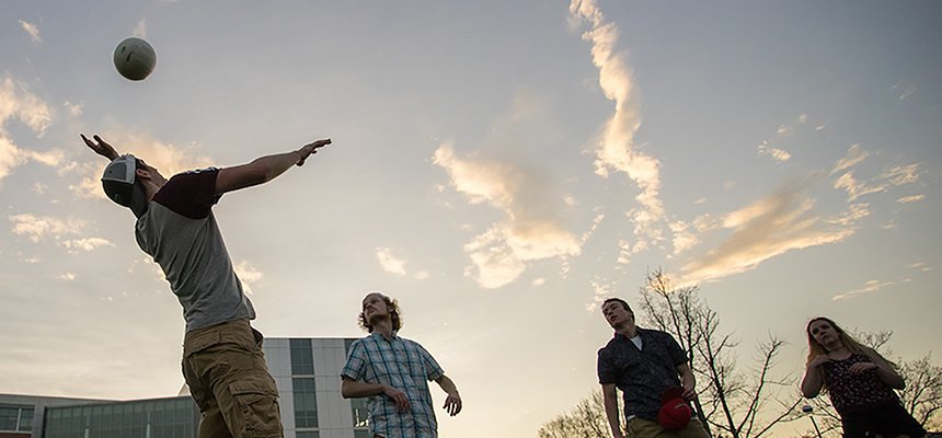 Students playing volleyball.