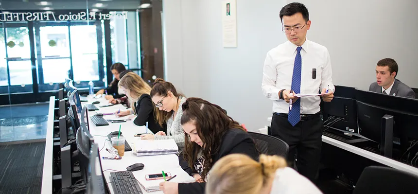 Professor teaching students at computers