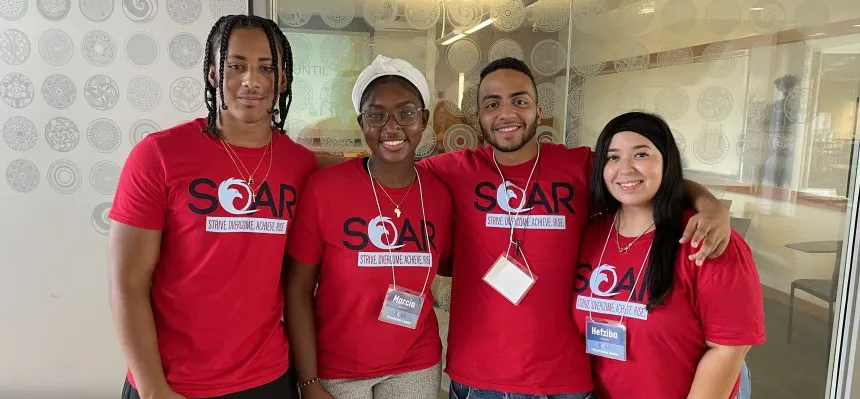 A group of students wearing S.O.A.R. t-shirts
