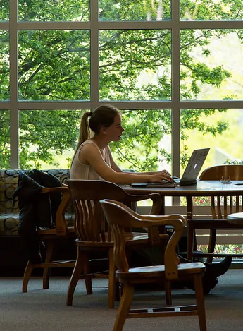 Student at library table