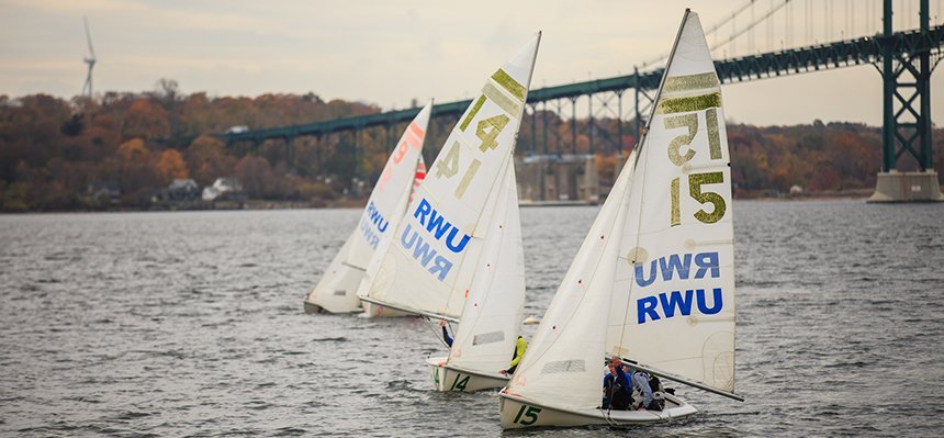 Sailing team practicing on RWU waterfront.