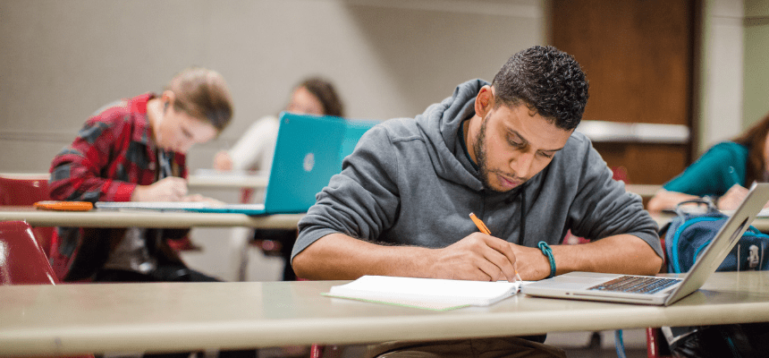 Student sits in a classroom writing