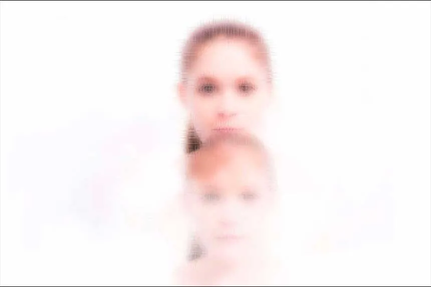 The heads of two girls on top of one another.