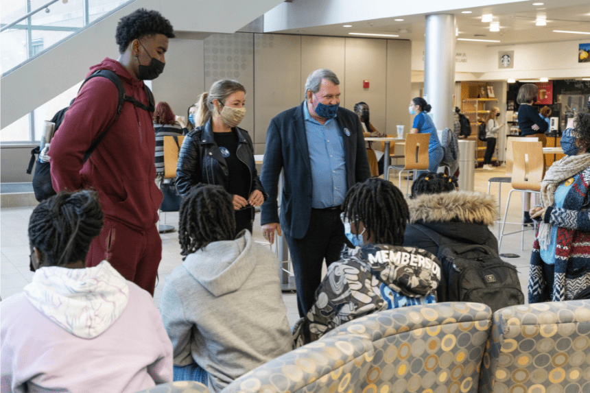 President Miaoulis and wife Heidi speak with students