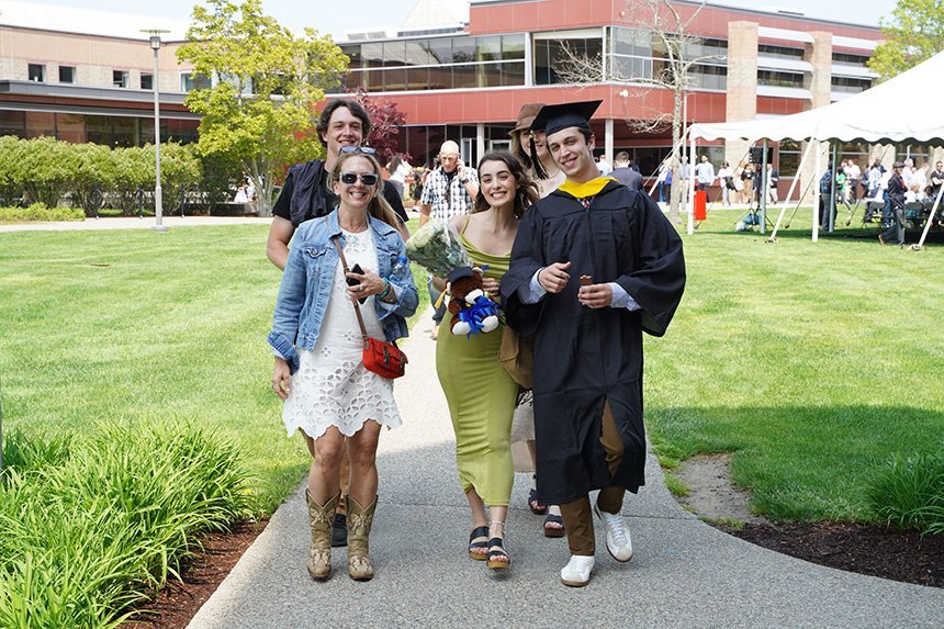 Graduates exit ceremony with family and friends