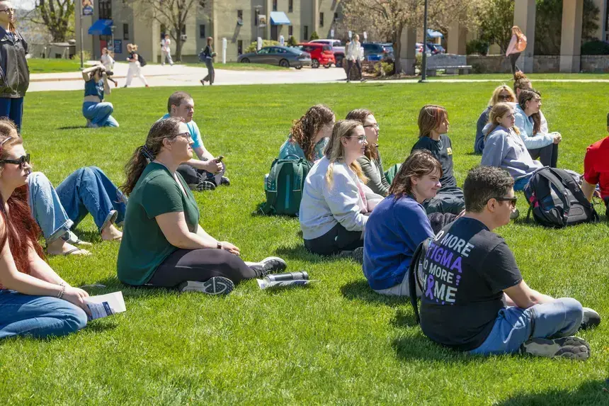 Students sitting on the grass.