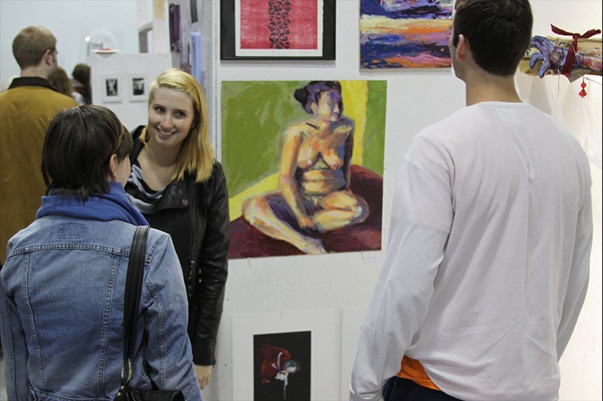 A photo of students inspecting art