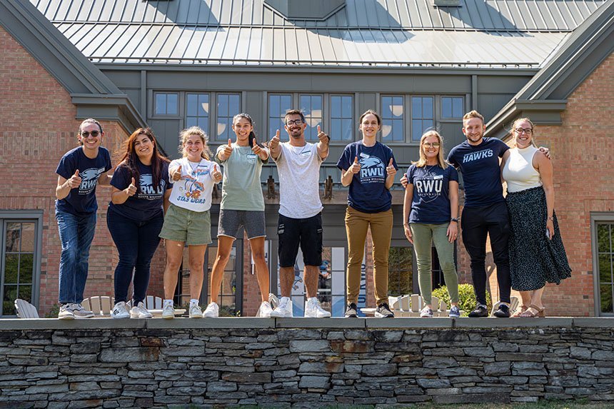 Admissions staff and students give a thumbs up to students processing to Convocation.