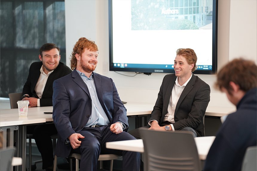 Two student presenters sharing a laugh at SASH 