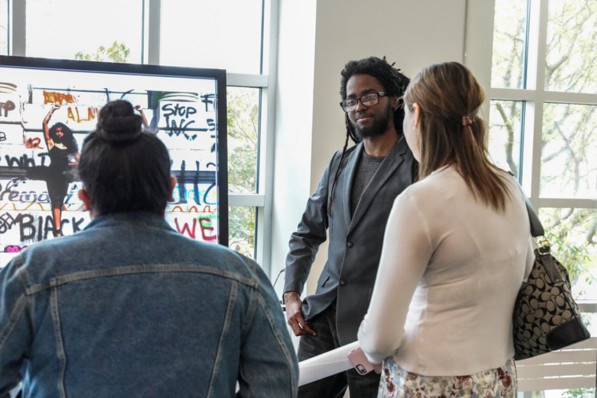 A student presenting his project at SASH 