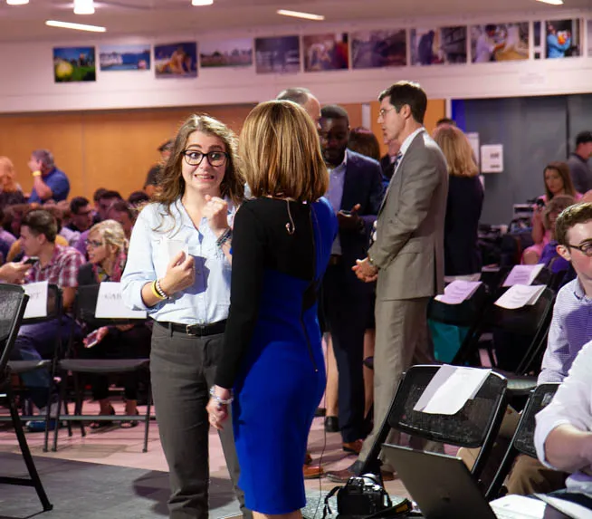 News Anchor talks to student.
