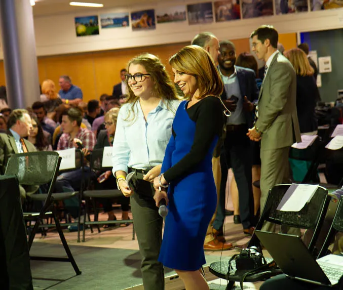 News Anchor talks to student.