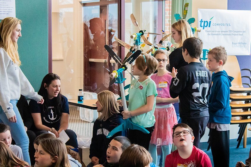 fourth grader holding a wind turbine