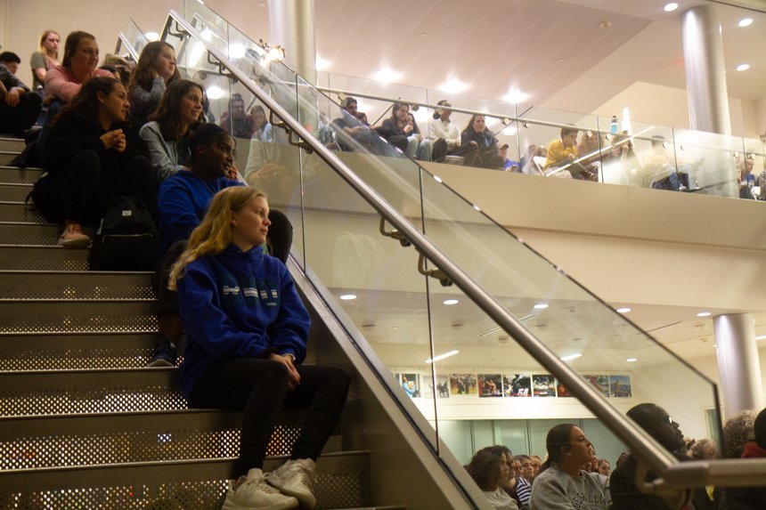 Audience sitting on stairs.