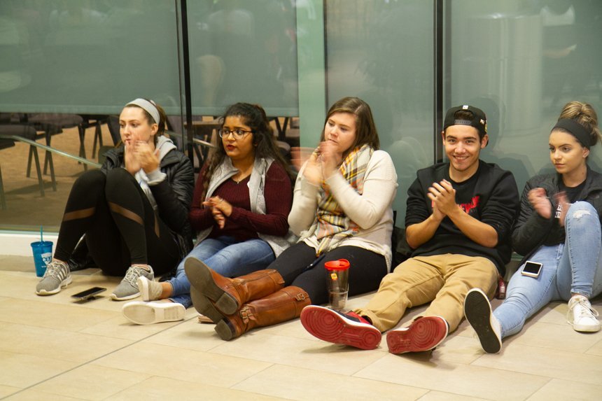 Audience sitting on floor. 